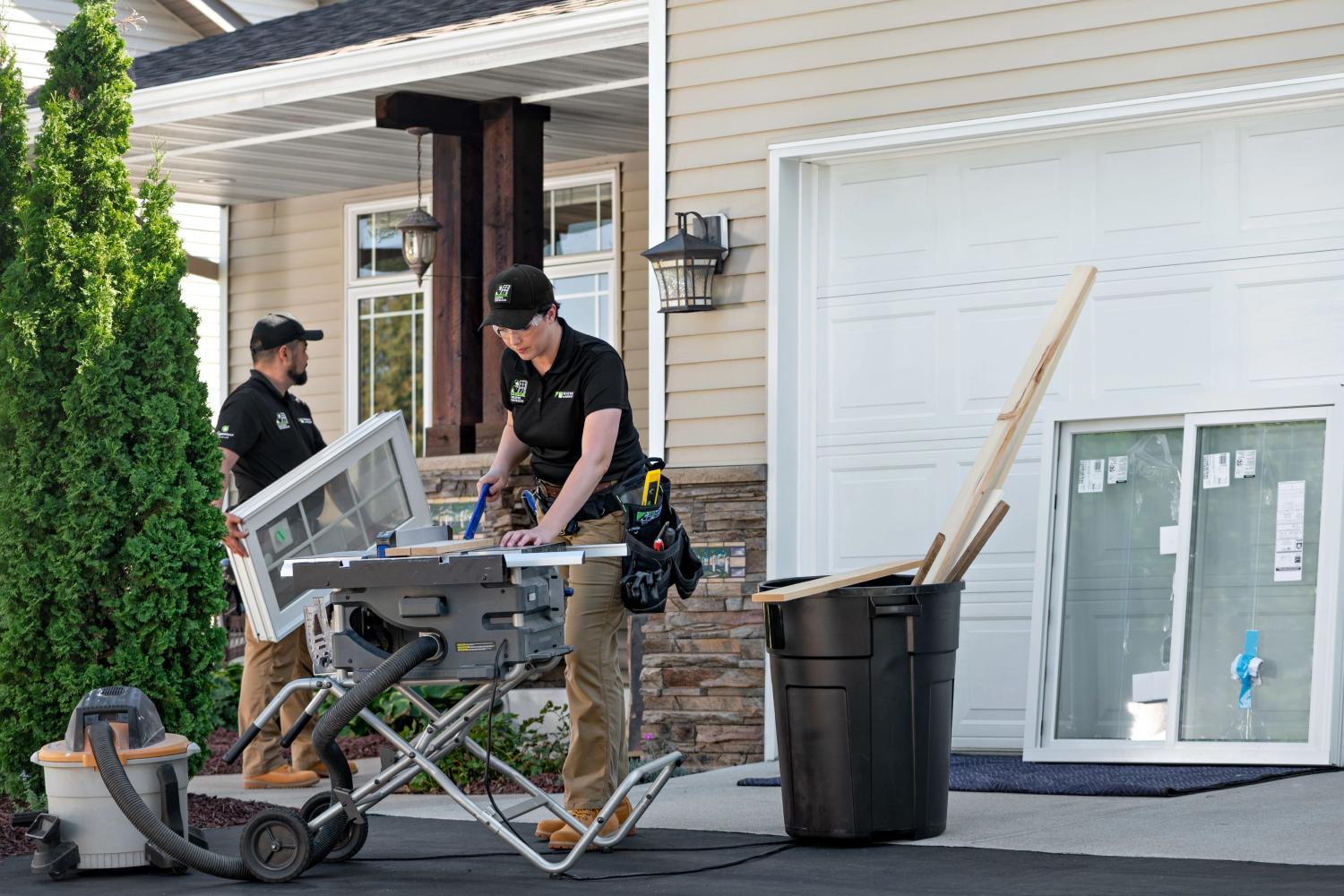 Renewal by Andersen installers setting up to install new windows at a homeowners residence