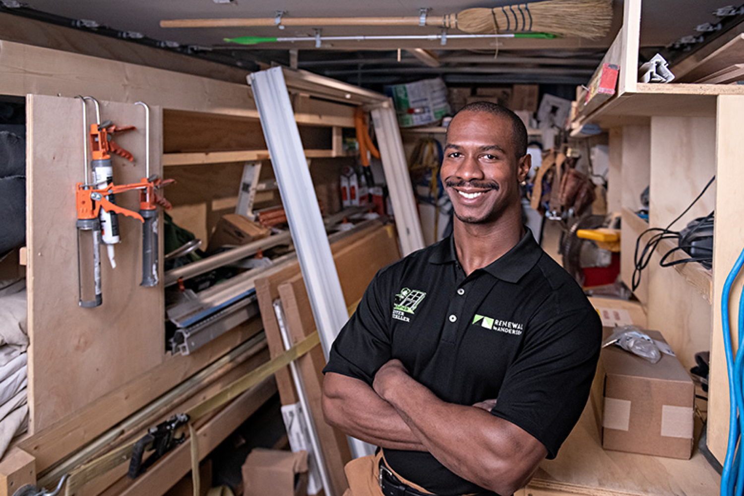 Installer standing in a room full of window installation materials