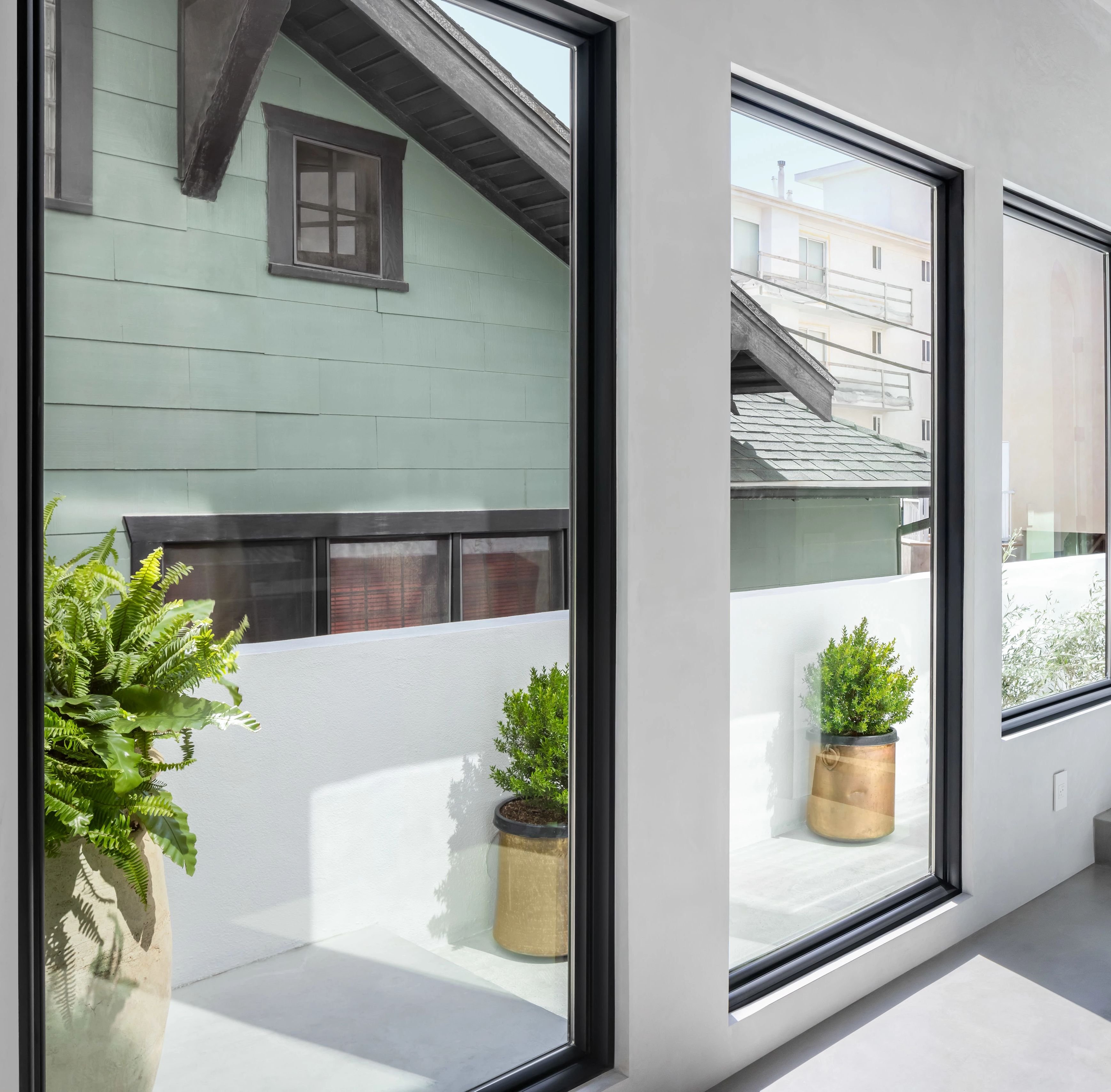 Large picture windows in the hallway of a coastal home.