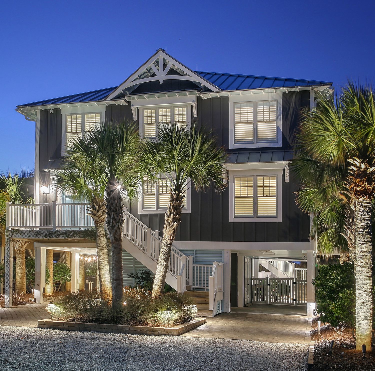 A three-story coastal home in the evening.