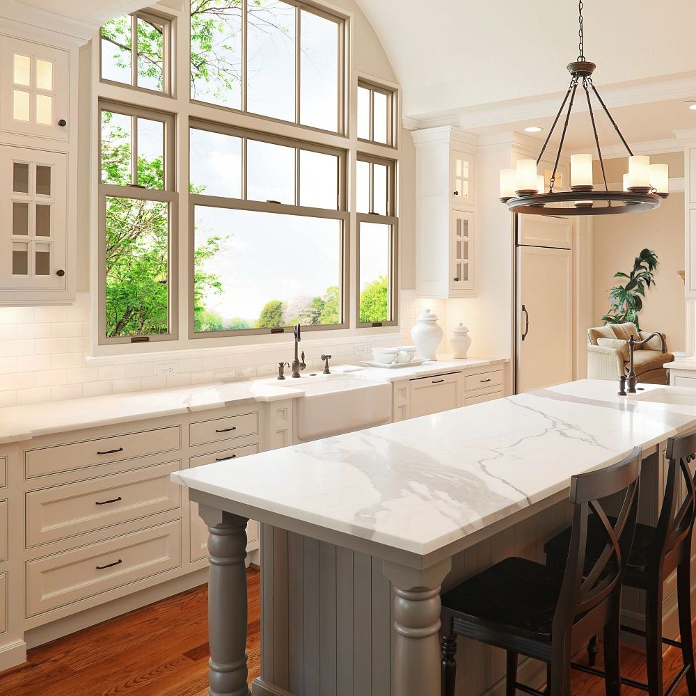 Extra-large double hung windows with divided light grilles paired with picture windows