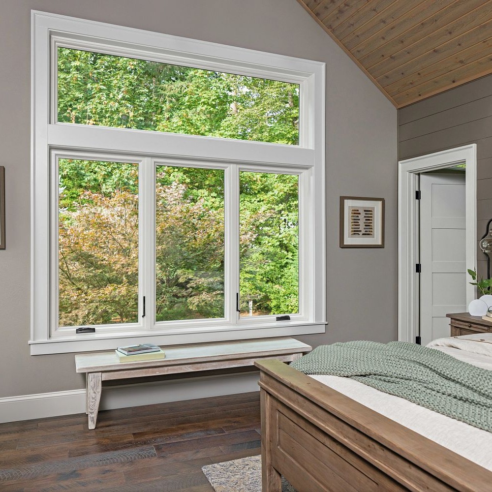 A bedroom with casememt windows