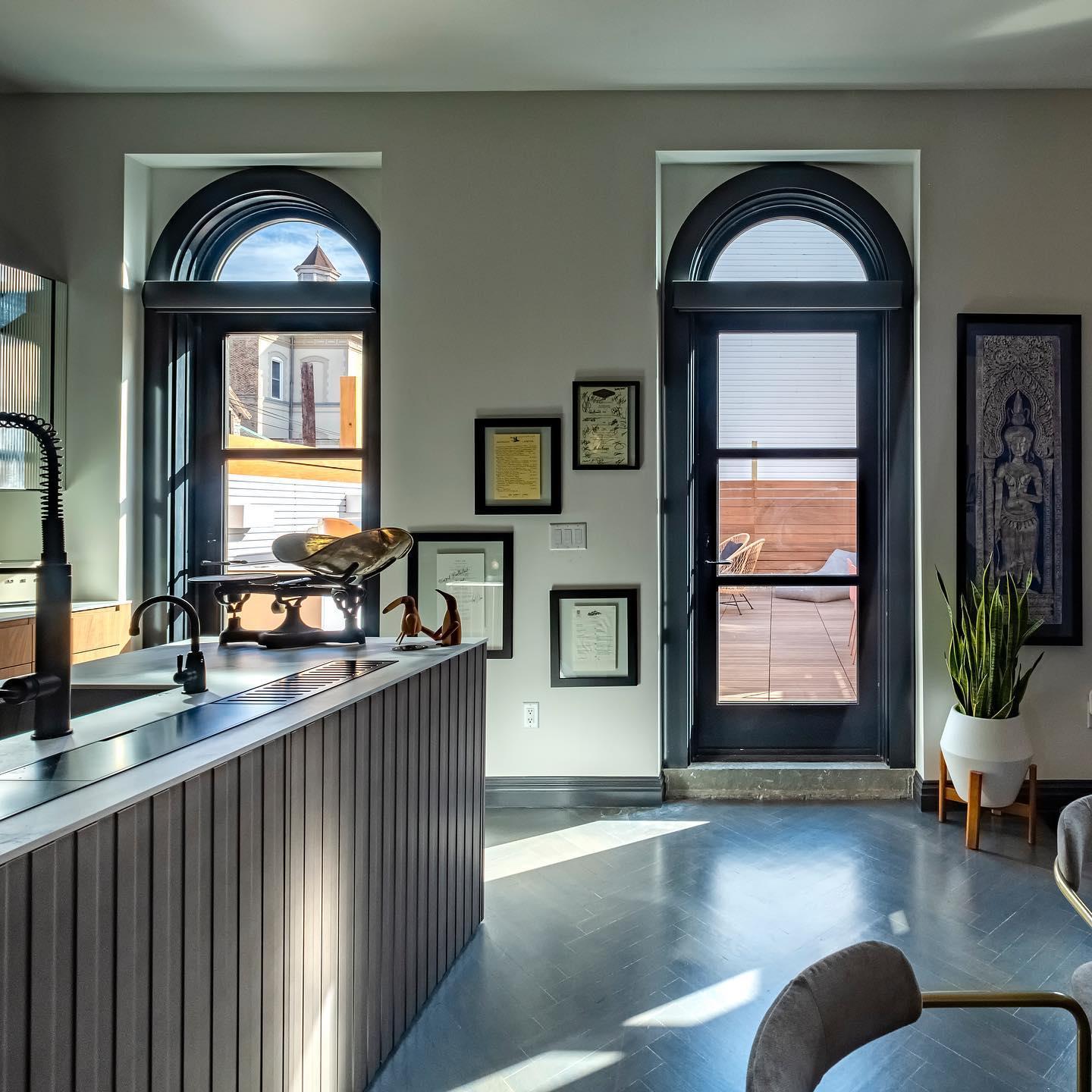 Tall black-framed windows with a circle top.