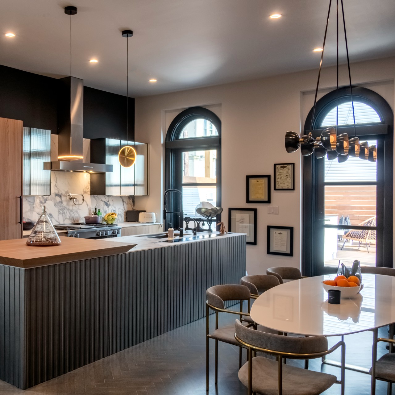 The kitchen in Anthony's house features an island with a mix of textures. It ties into the cabinetry in color scheme. 