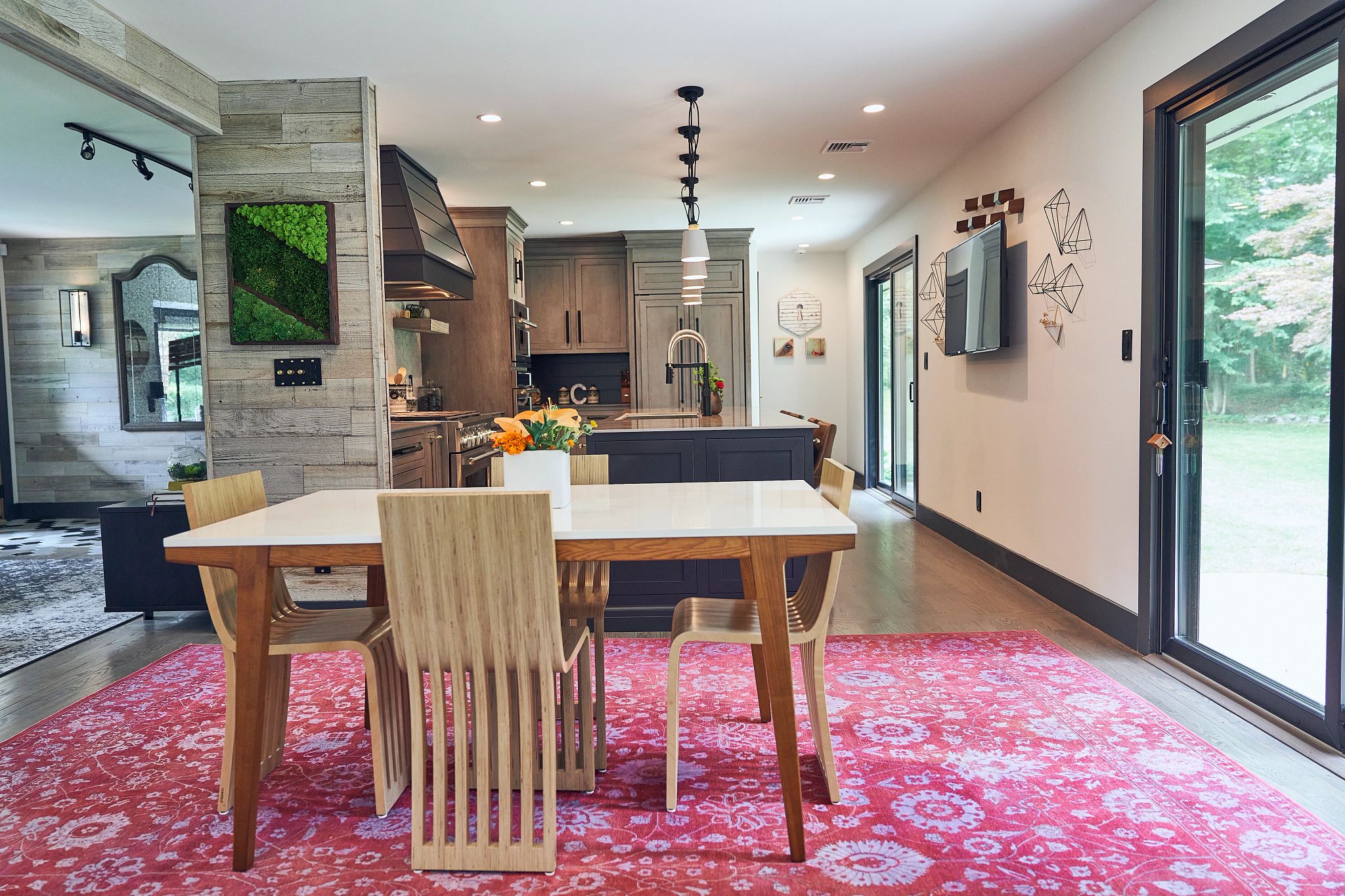 John's living and dining and kitchen space. There is another large rug.