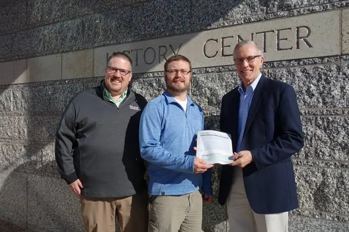 Renewal by Andersen employees stand in front of History Center presenting a check to support Fort Snelling.